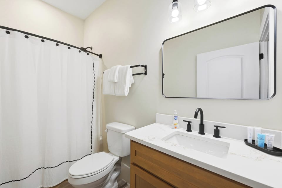 Full Bathroom 2: This bright and inviting full bathroom provides a convenient place to shower, refresh, and get ready comfortably throughout your stay.