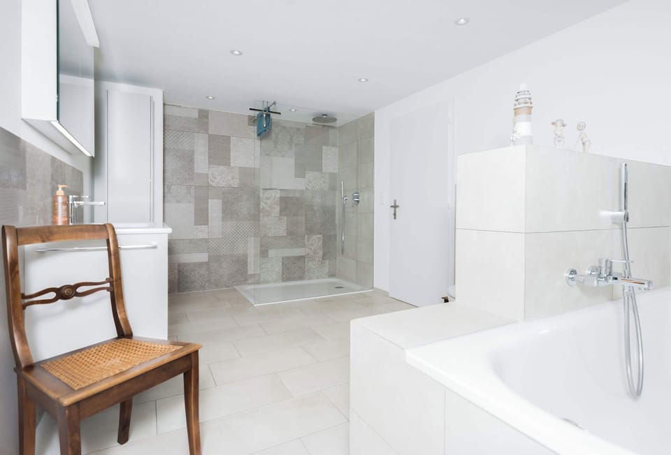 Spacious shared bathroom with bathtub, shower, and plenty of room to get ready.
