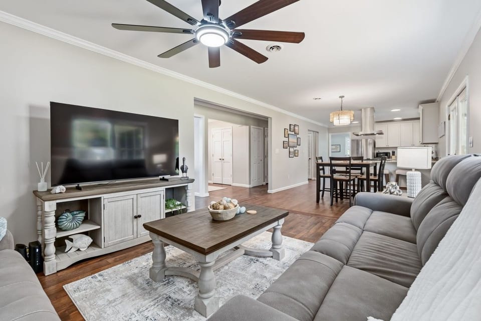 One easy, open flow from the living room through the dining area to the kitchen — room for the whole group to spread out.