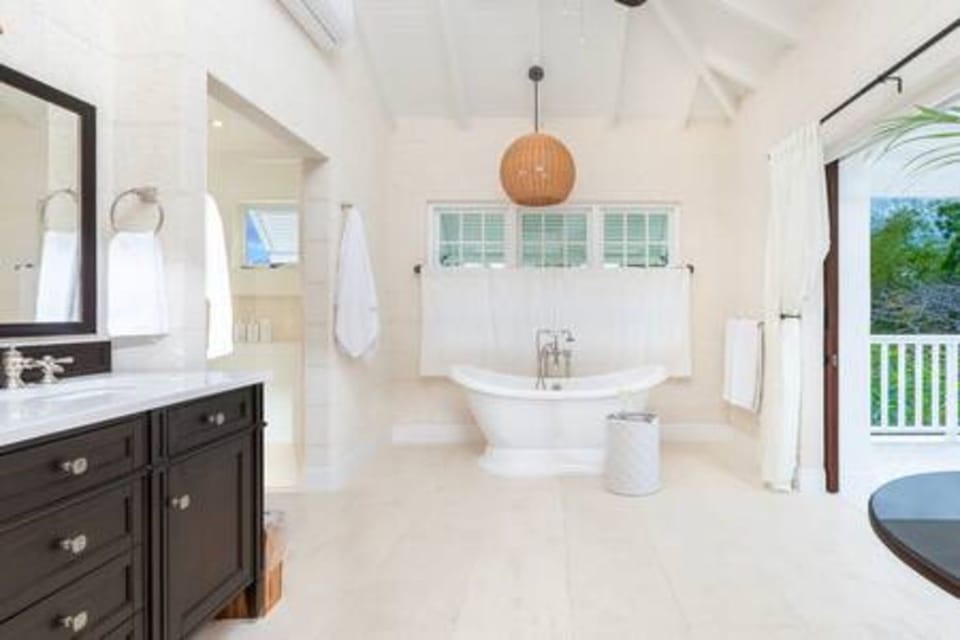 Light and spacious master en suite bathroom with free standing bath, double vanity unit, walk in shower, bath robes and private balcony.