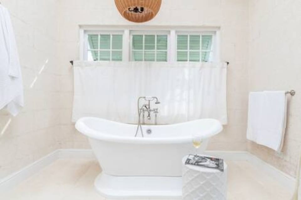 Light and spacious master en suite bathroom with free standing bath, double vanity unit, walk in shower, bath robes and private balcony.