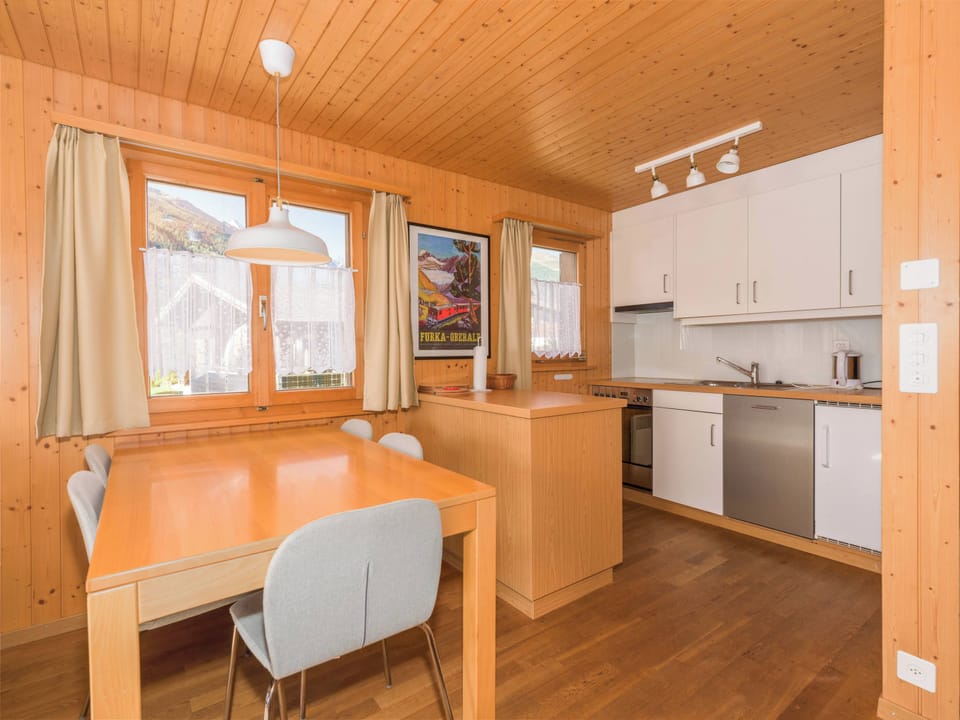Open kitchen and dining area with practical workspace, dishwasher, and everything needed for meals at home.
