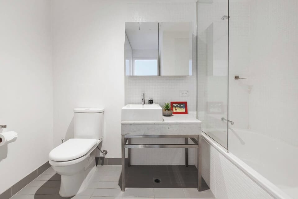 The ensuite bathroom offers a shower and bathtub combination for a refreshing soak after a long day. 