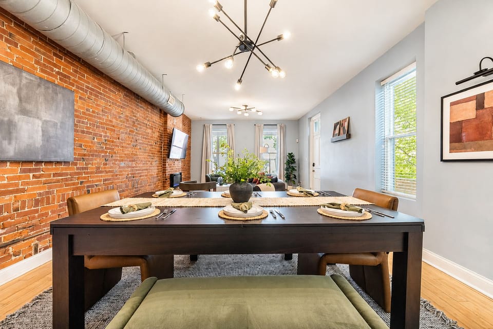 Gather around the outdoor dining table for six, surrounded by leafy trees and warm string lights—a lovely spot to share a meal and unwind together.