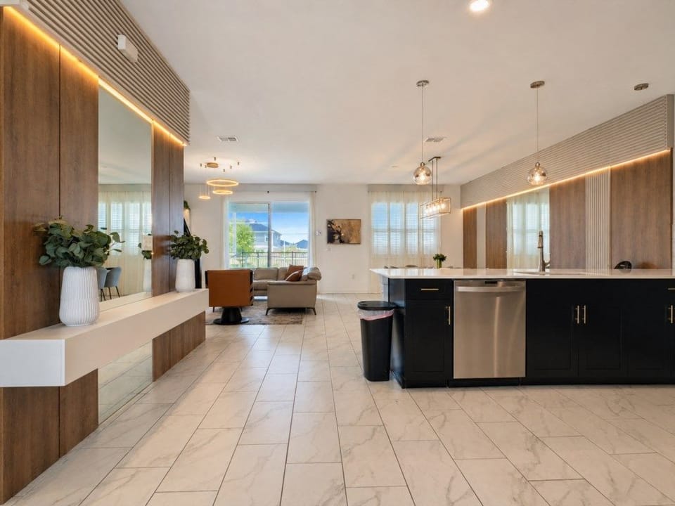 Bright open-concept living, dining, and kitchen area with modern finishes.
