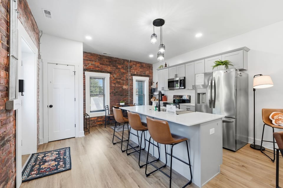 Gather around the spacious kitchen island with comfortable barstool seating. Great for morning coffee before heading out to explore Science Central nearby.