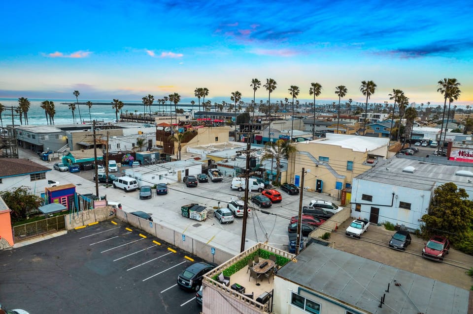 🌅 Sunset views over rooftops toward the pier—a rare vantage point that captures the whole coastal town at golden hour.