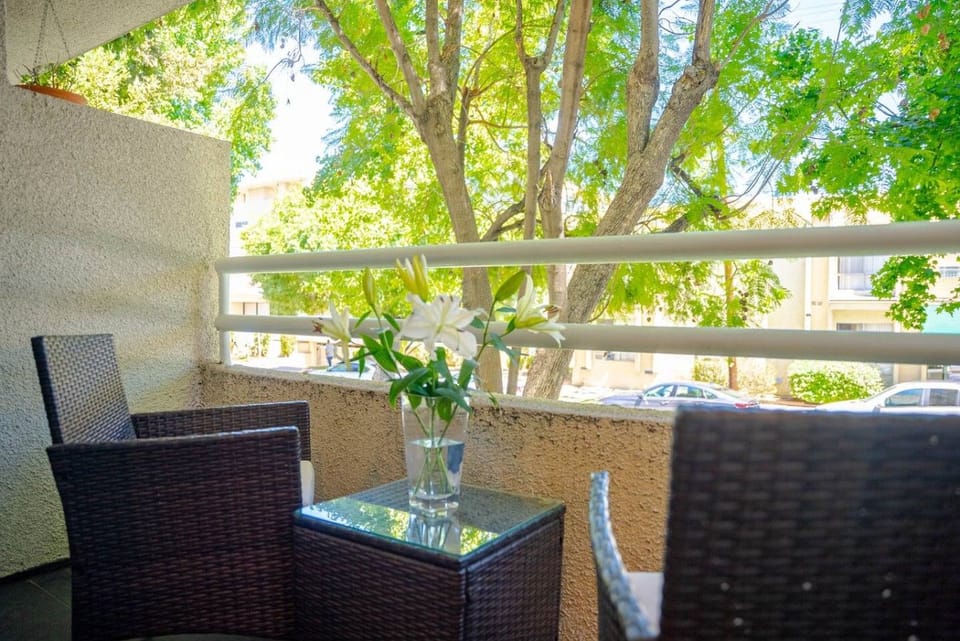 Private balcony off the living room, where the plantation shutters open to catch the morning light