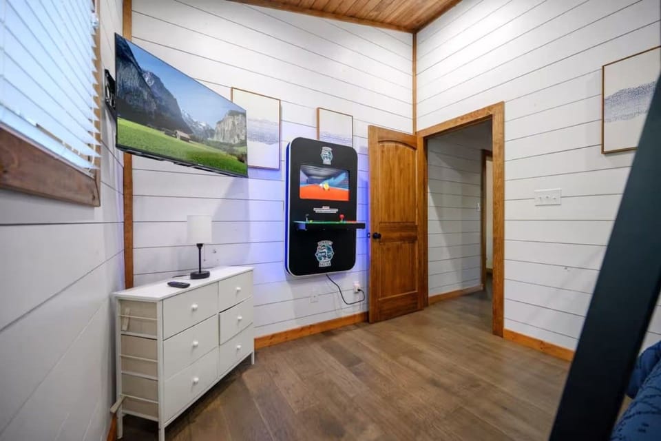 Cabin bunk room with arcade game