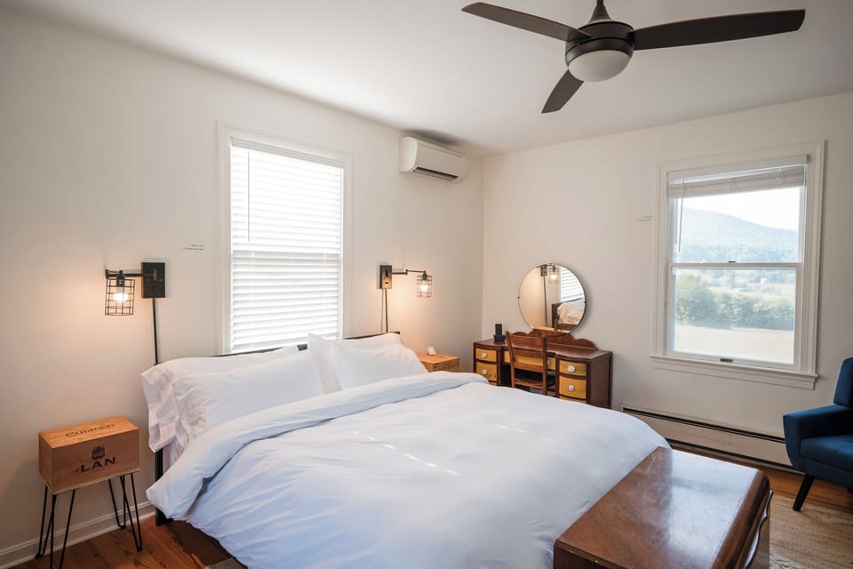 Light-filled king bedroom with mountain views
