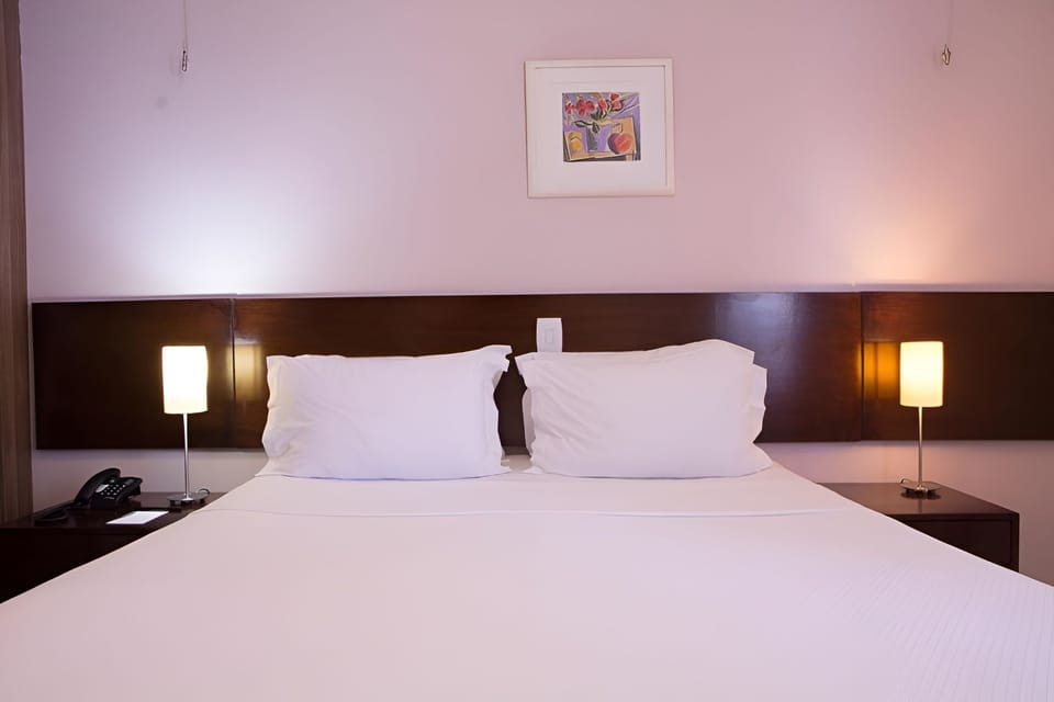 Sink into soft pillows under warm bedside glow.