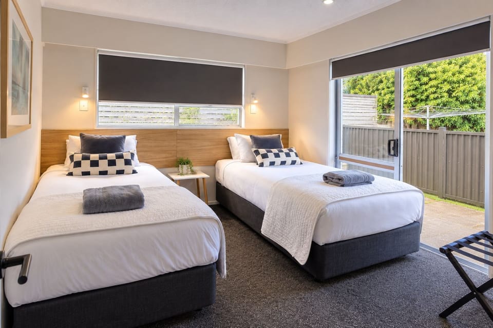 Bright twin room with garden access and fresh, modern styling