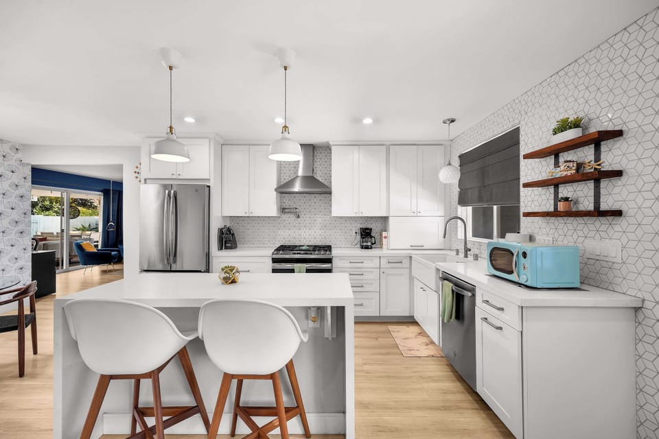 A sleek kitchen with a spacious island, stylish accents, and everything you need.