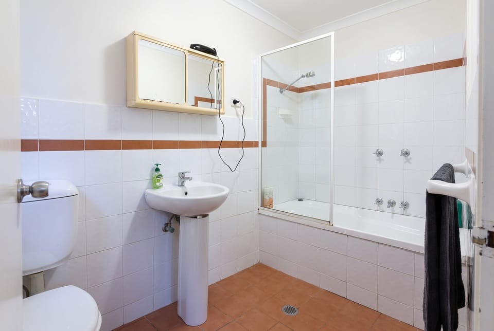 Private bathroom with bath and shower