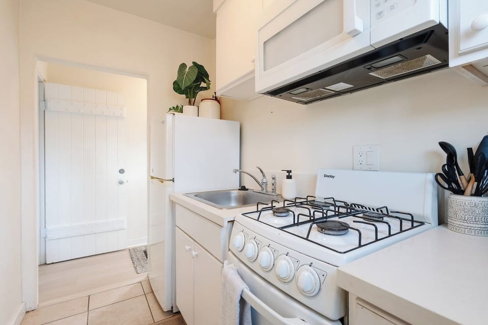 The compact kitchen comes equipped with all the cooking essentials