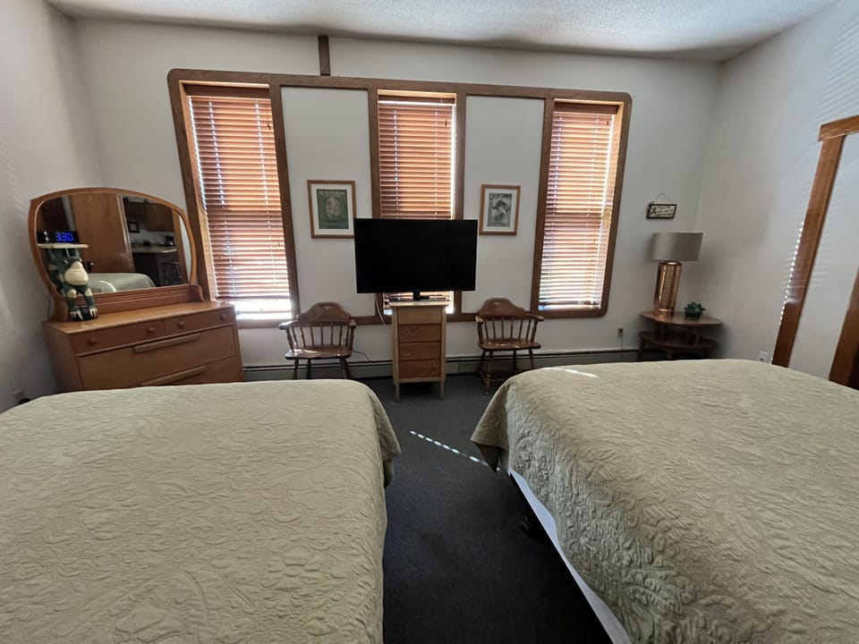 Spacious rooms with tall windows offering charming street views for a bright and airy stay.