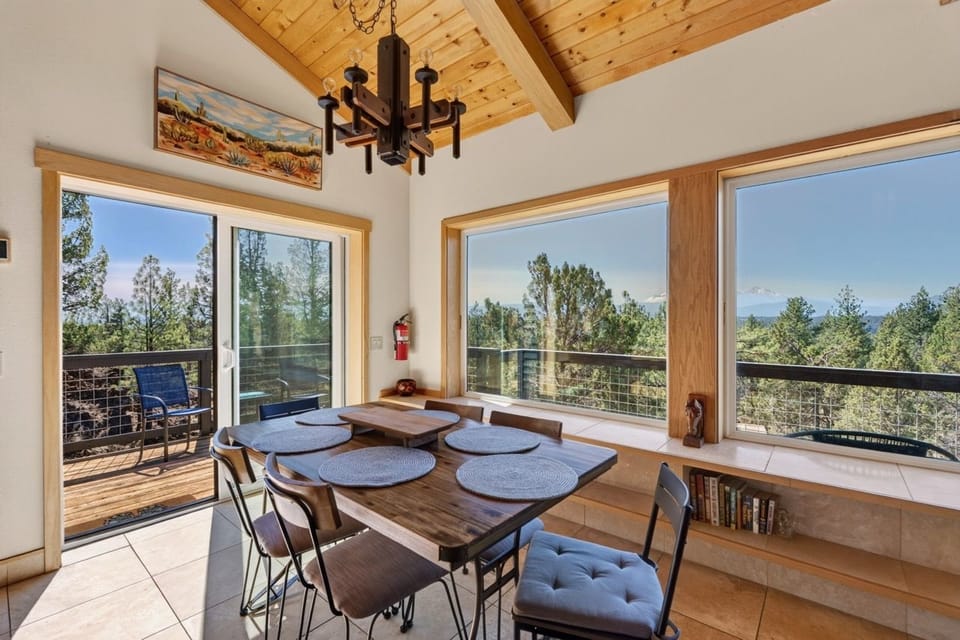 Gather around the handcrafted wooden table surrounded by sweeping mountain vistas through floor-to-ceiling windows, where every meal becomes a special occasion framed by nature's beauty.