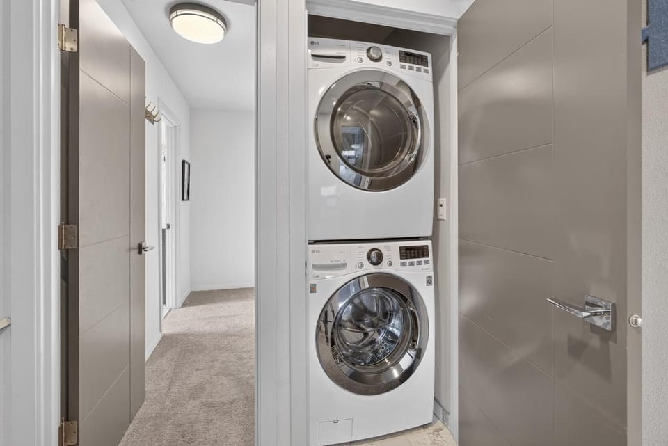 Convenient in-unit washer/dryer tucked into a bright modern hallway