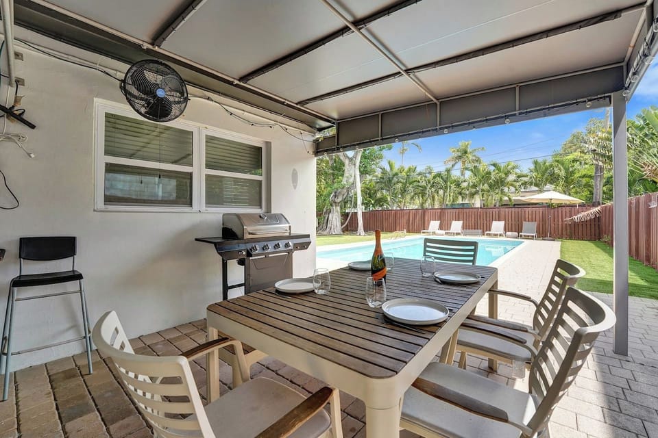 Covered Patio with Outdoor Dining and Pool Views