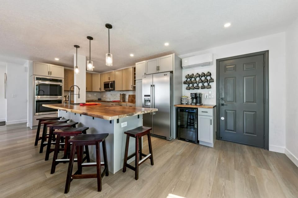 The thoughtfully designed kitchen features a double oven for large family meals, plus a wine fridge to keep your favorite vino perfectly chilled.