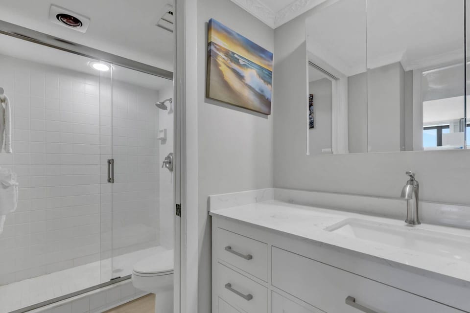 The updated primary ensuite offers a bright vanity and glass-enclosed walk-in shower for an easy start to the day.