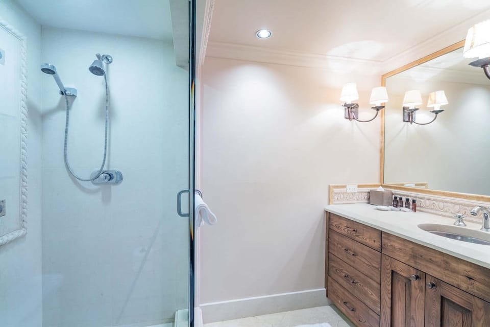 Bathroom with glass shower and wooden cabinetry