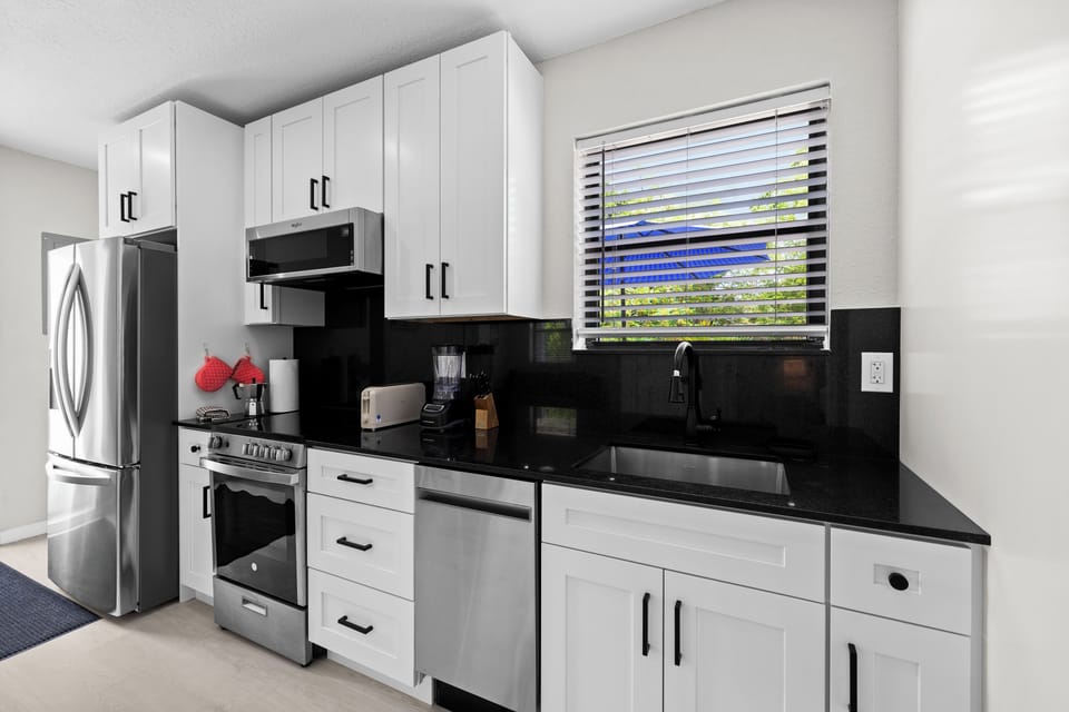 Main kitchen. Plenty of cabinets, dishwasher, microwave, stove top & oven. 