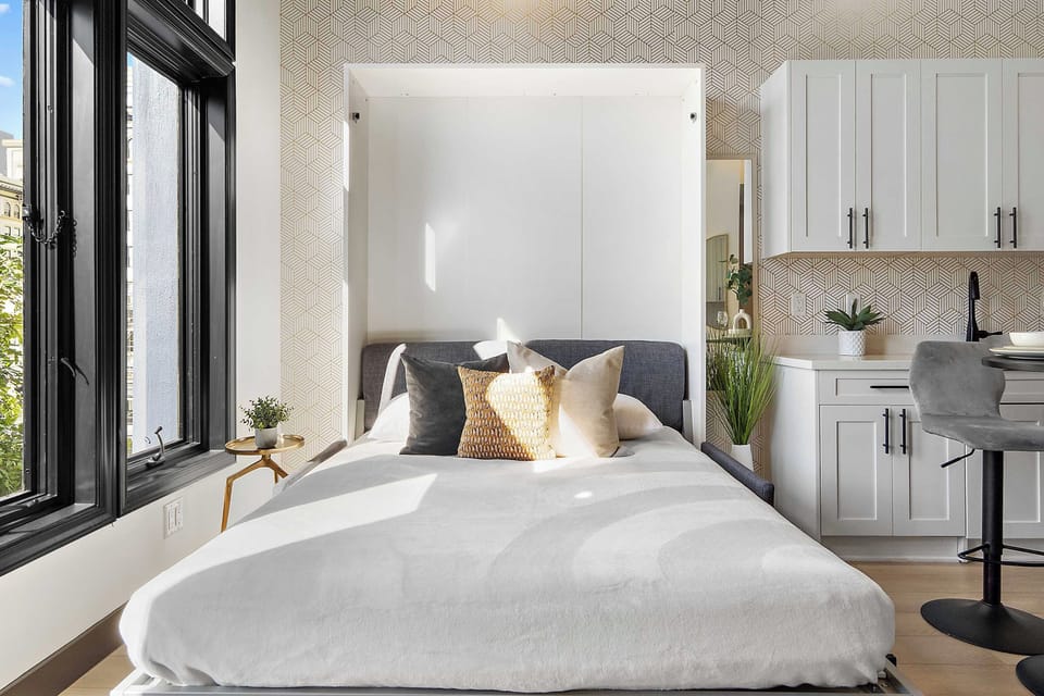 🛏️ Murphy bed down beside the kitchen—smart design that turns living space into sleeping space in seconds.