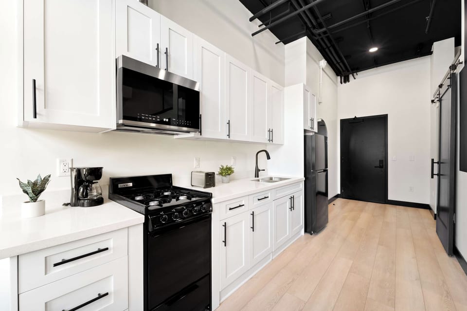 🍳 Clean-lined kitchen with dark hardware and full appliances—everything you need to cook like you're home.