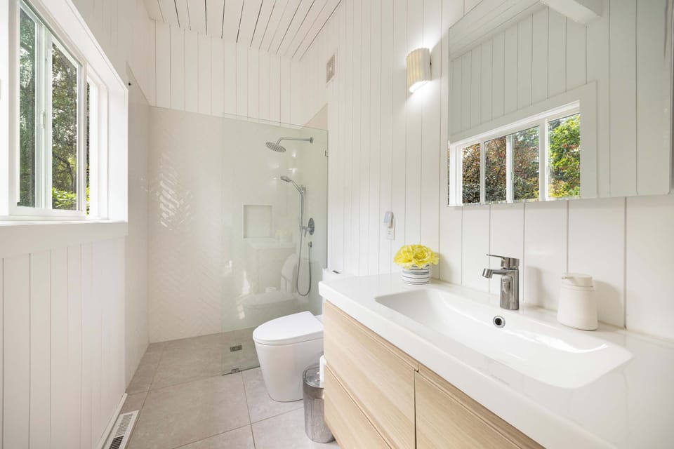 Bright bathroom with a walk-in shower.