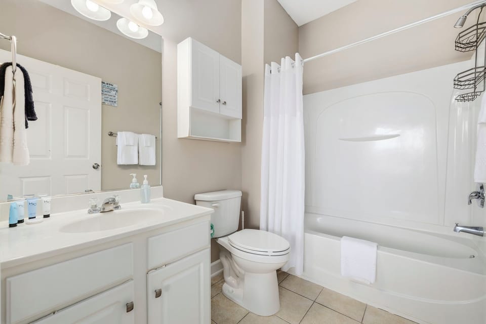 Refresh after a day at the beach with a full shower and tub setup.