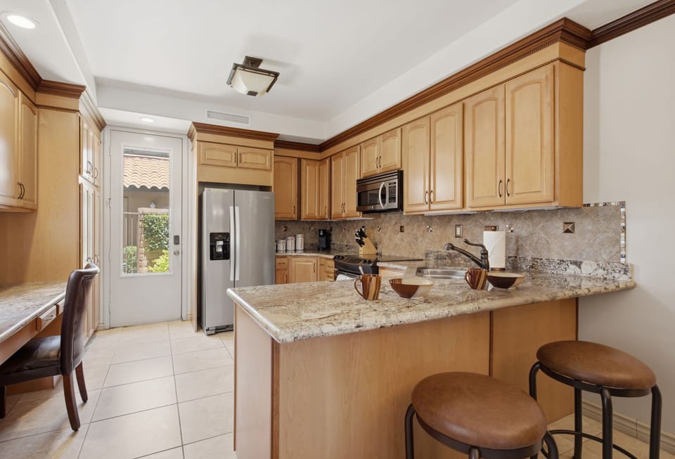 Spacious kitchen with breakfast bar and abundant counter space.