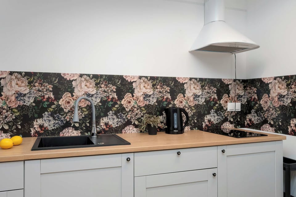 Essential appliances like a microwave and an extractor hood are neatly installed.