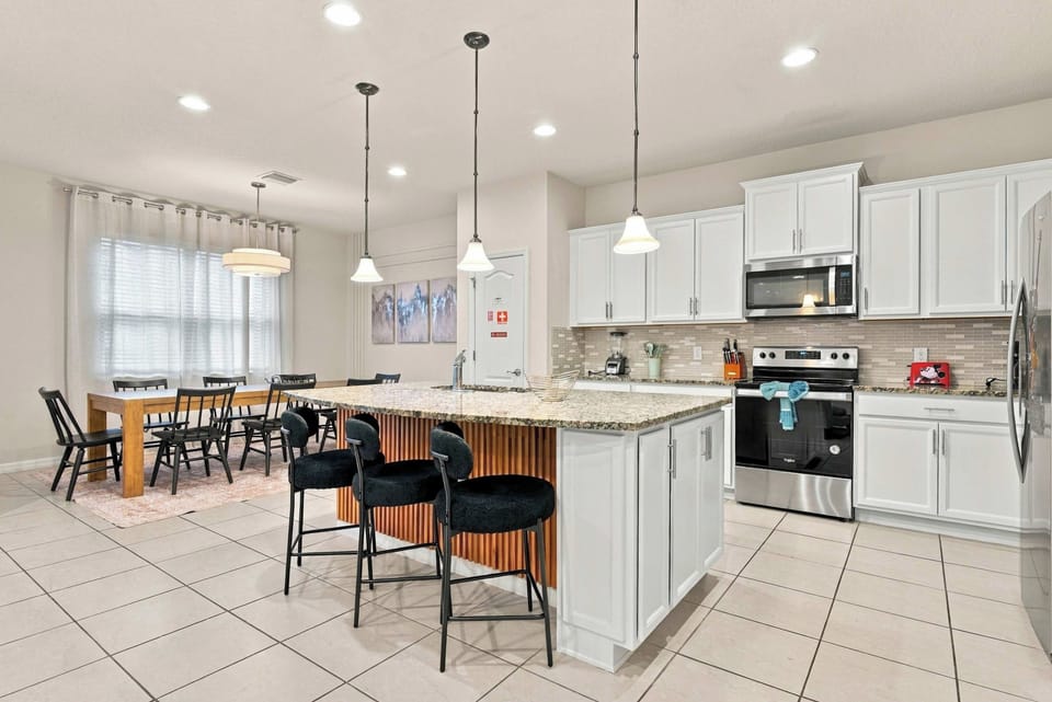 Kitchen with island seating for 3 and stainless appliances