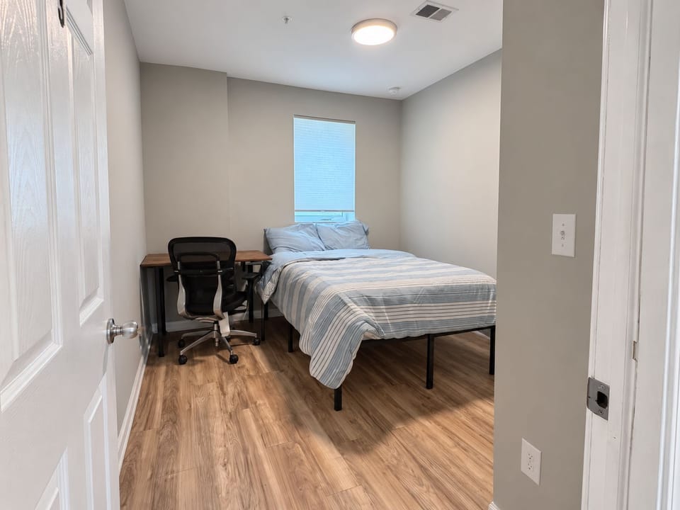 Sleep soundly on a comfortable queen bed with crisp striped blue bedding.