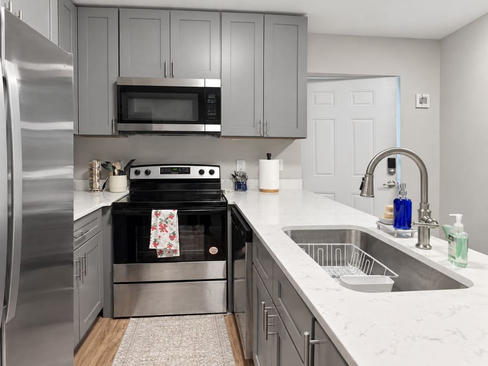 Prep dinner easily on stunning white marble-style quartz countertops.