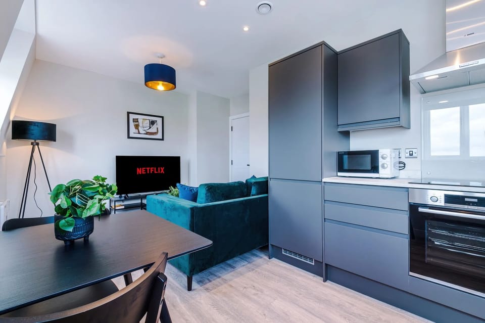 Spacious living room with comfortable seating and inviting atmosphere, perfect for relaxing or socialising during your stay.