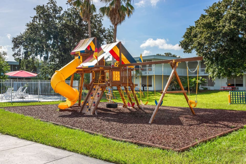 Colorful playground with slides, swings, and climbing walls