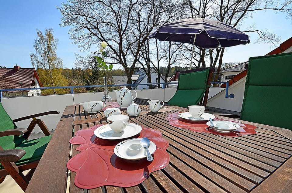Just 250 meters from the sandy Baltic Sea beach, balcony with patio furniture and a beach umbrella Apartment in Glowe