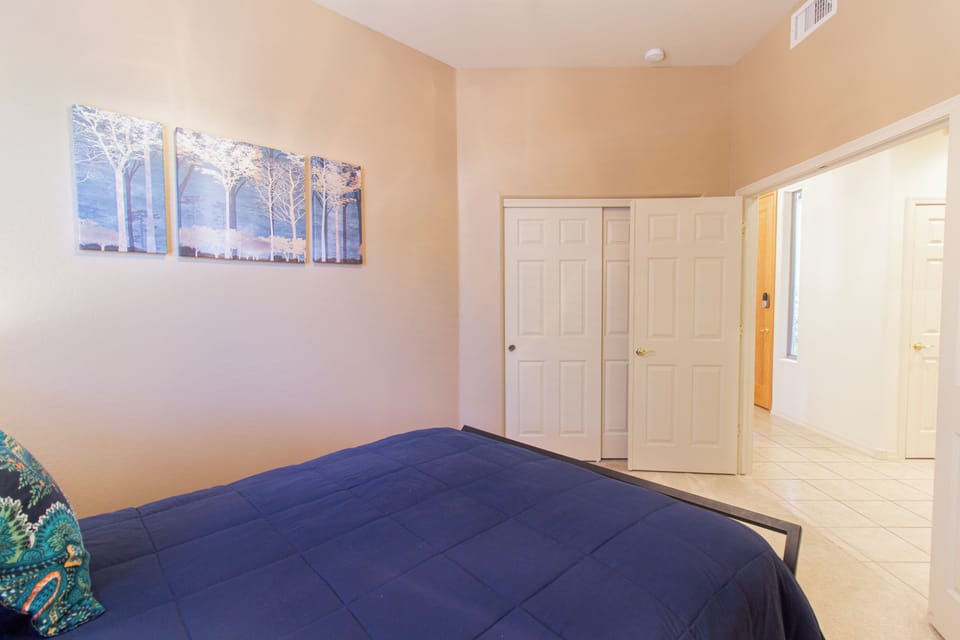 Bright, airy bedroom with high ceilings and convenient closet space