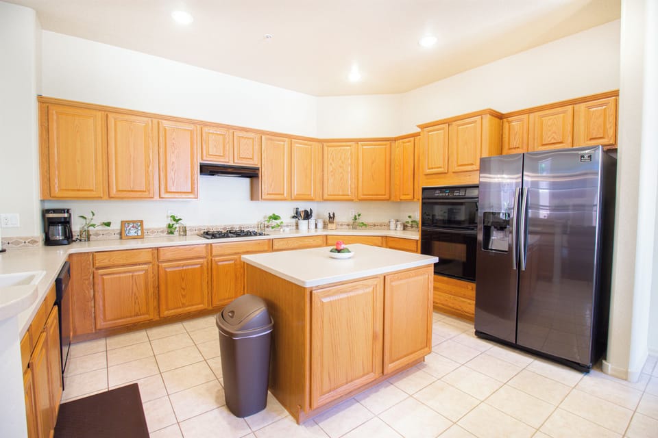 Bright spacious kitchen with island, ample storage, and stainless appliances