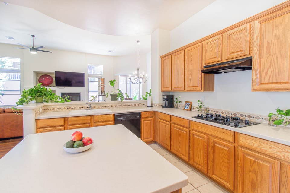 Bright open kitchen with large island, gas cooktop, and coffee bar