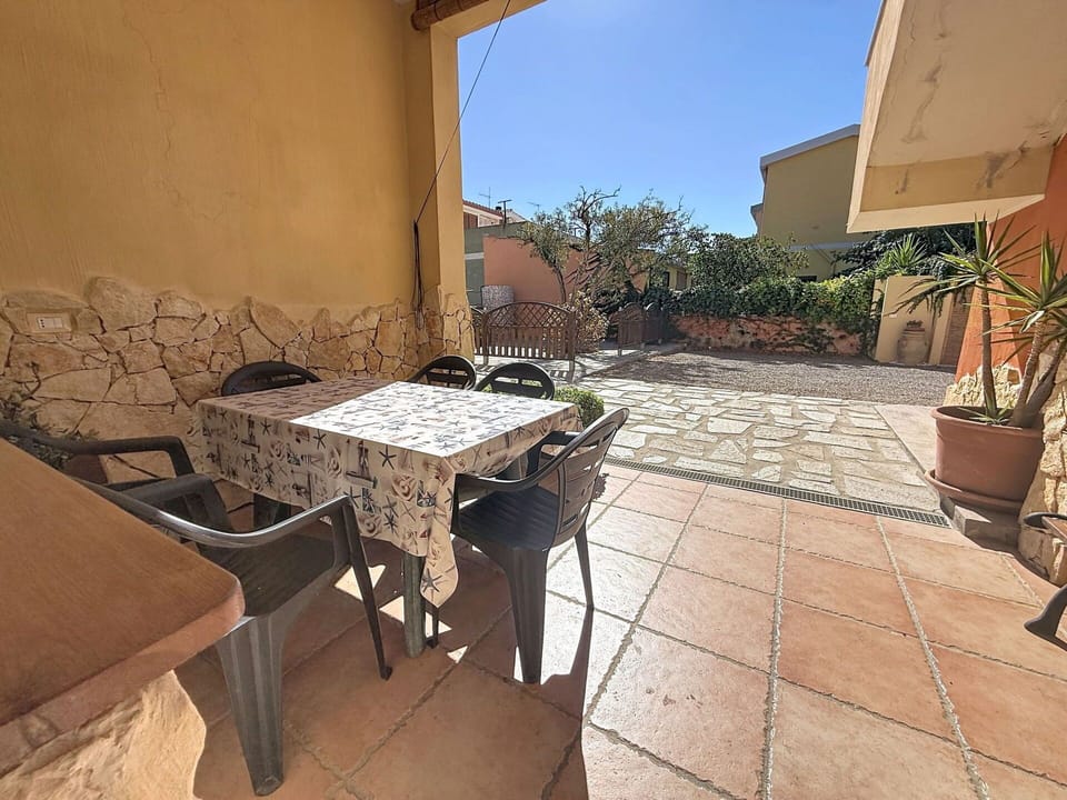 Flooring, Floor, Furniture, Door, Chair, Flowerpot, Outdoor Furniture, Flagstone, Shade, Houseplant