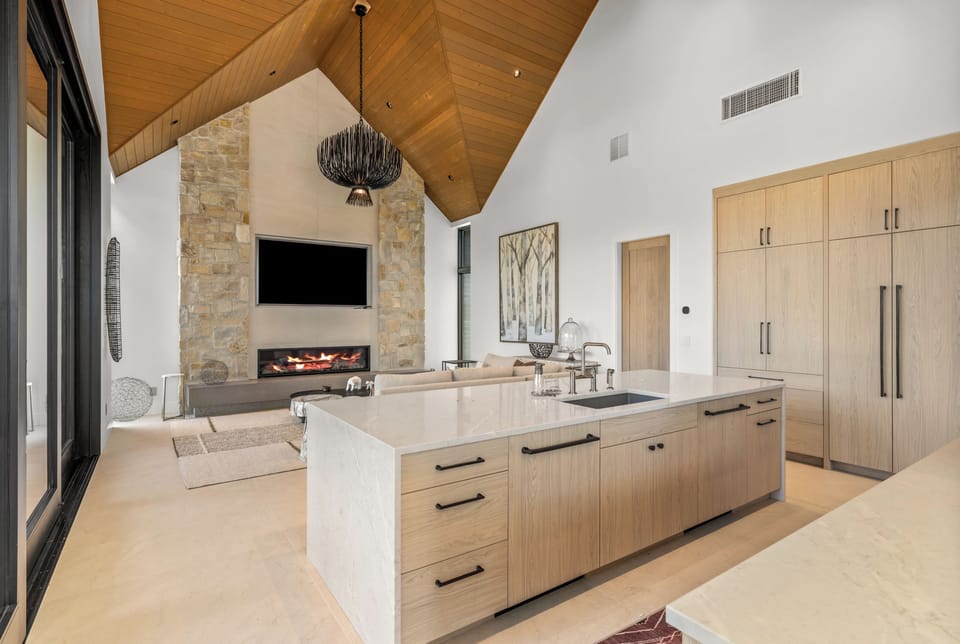 Main level open living and kitchen area with large fireplace for those snowy nights