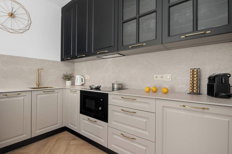 A bright interior space with wooden flooring and a view toward an open seating area. Clean architectural lines connect different zones of the home seamlessly.
