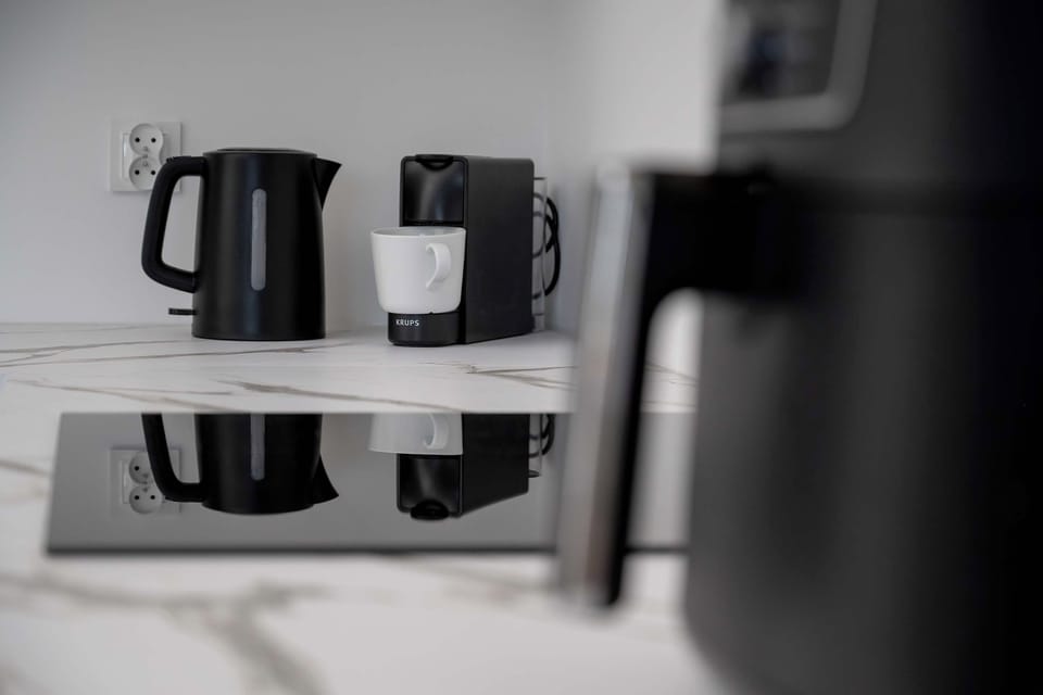 A detailed view of small kitchen appliances, including a kettle and coffee machine.