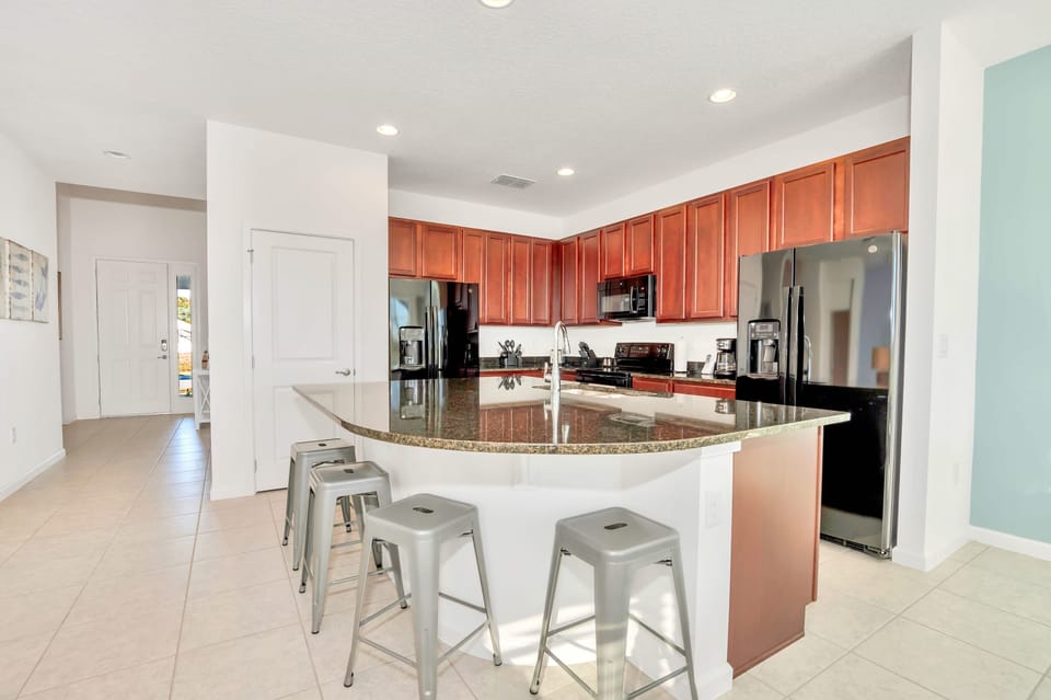 Fully Equipped Kitchen with Centered Island and Bar Stools