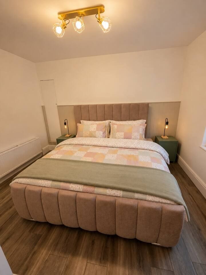 Cozy modern bedroom with plush king bed and warm ambient lighting