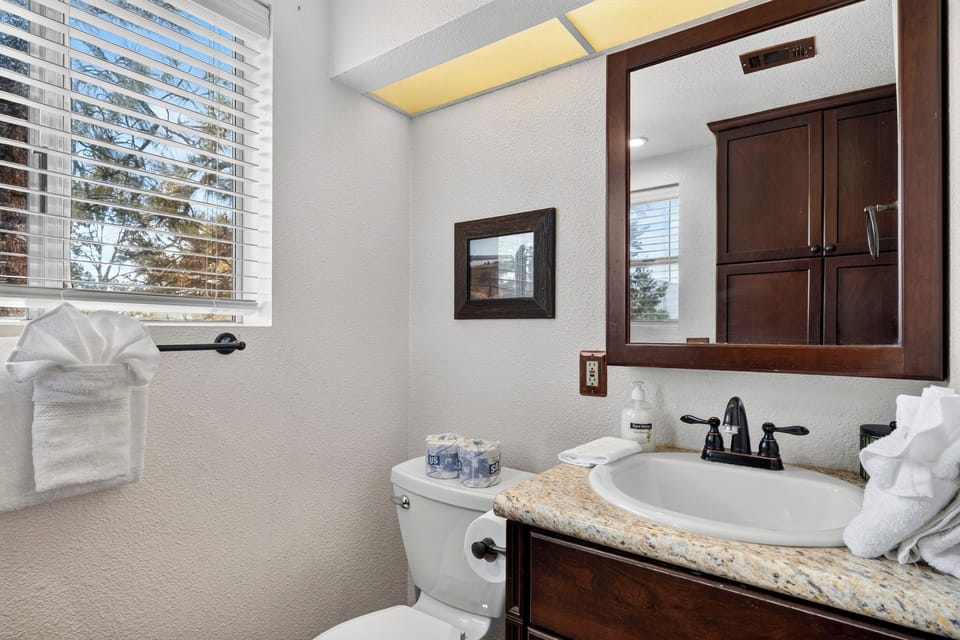 A fresh, well-appointed bathroom provides a comfortable space to get ready for the day.