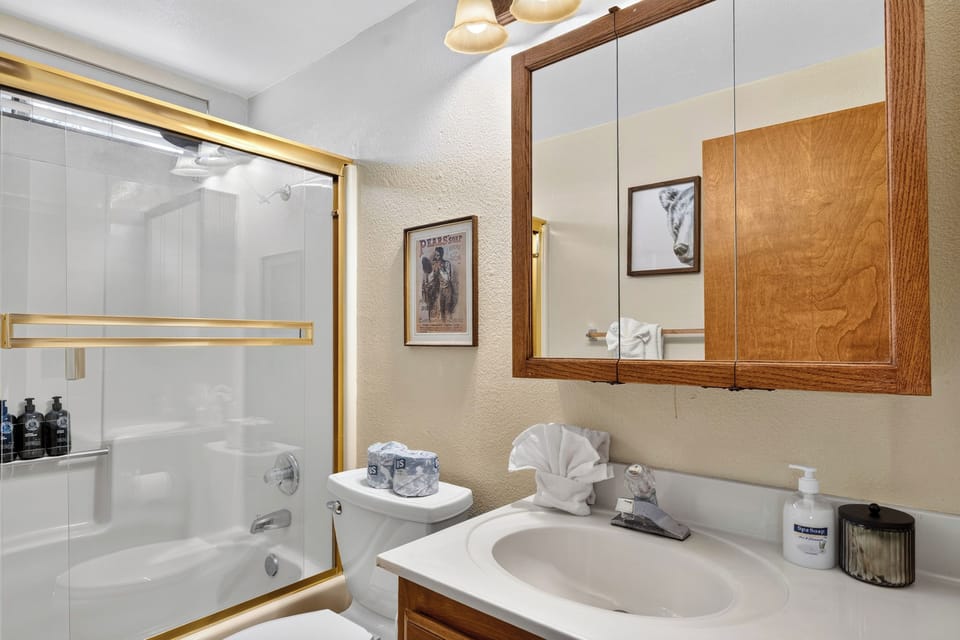 A bright full bathroom offers a shower-and-tub combination for easy family routines.